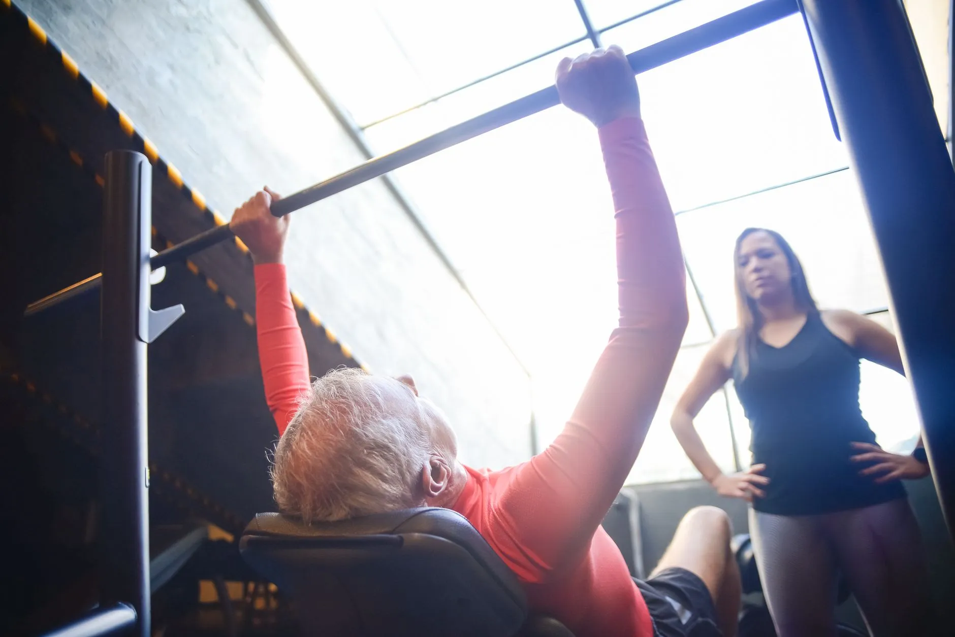 A man in his sixties training alongside a coach