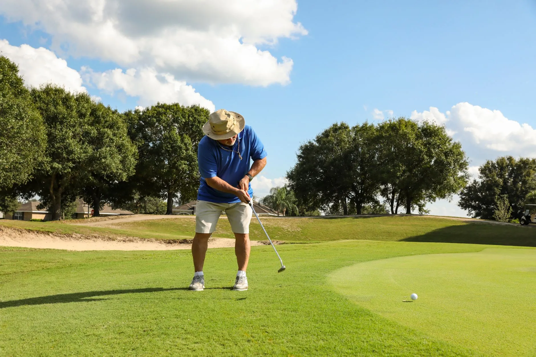 A golfer on a tree-lined course