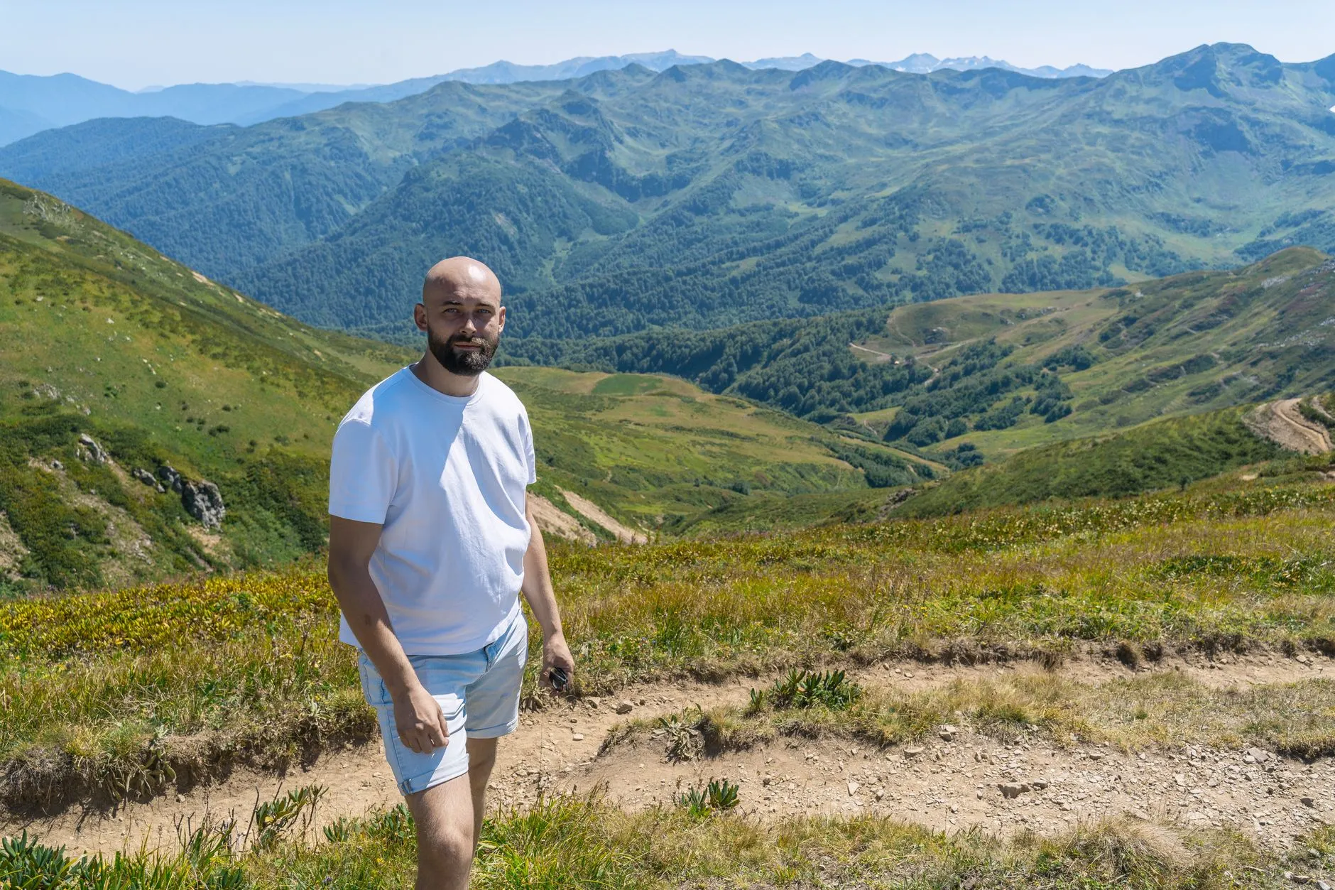 A hiker in green hills