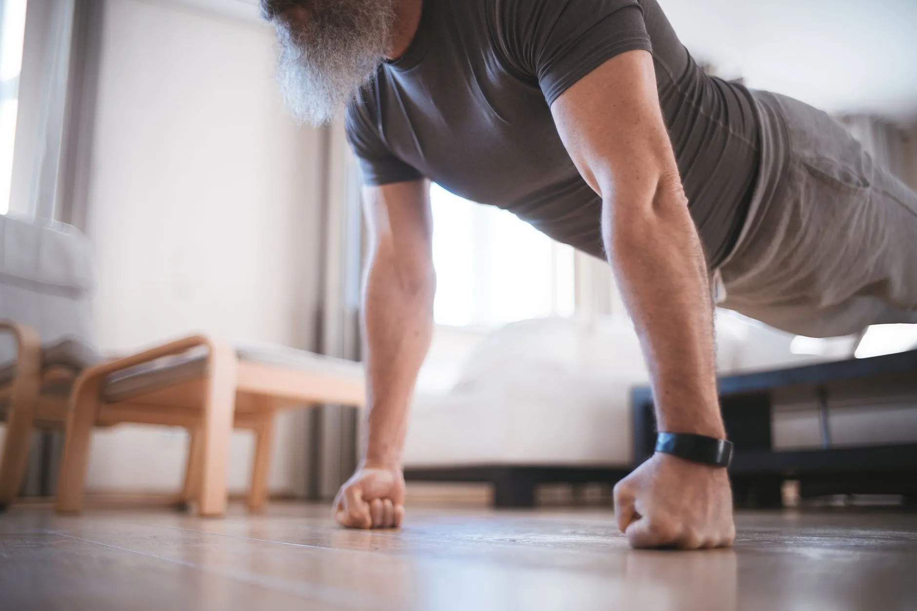 A man doing push-ups on the floor of a room